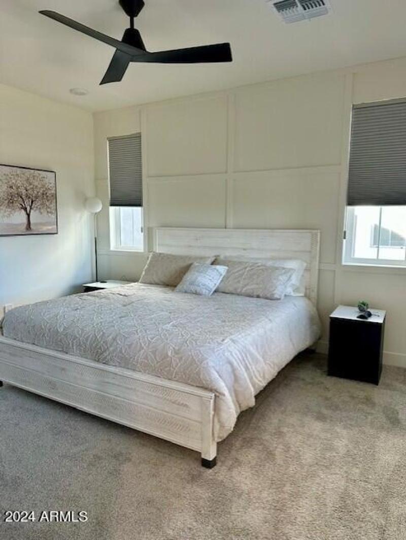 King bed in master bedroom with custom w