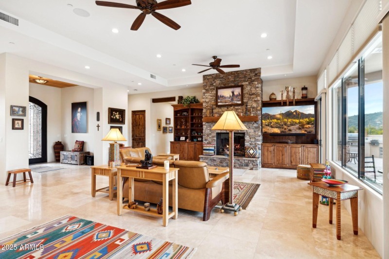 Fireplace surrounded by TV & blt-ins
