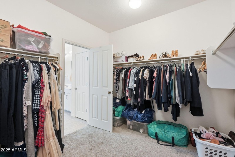 Primary bedroom walk in closet