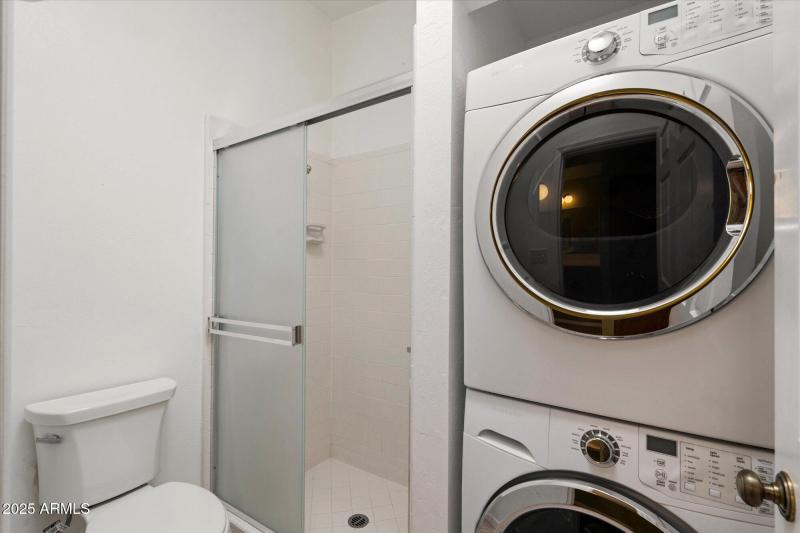 Master bathroom with stacked laundry