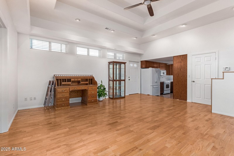 Great room with desk looking into kitche