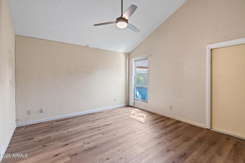 Primary bedroom with vaulted ceiling
