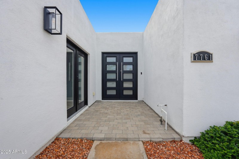 Front courtyard w/ dual steel doors