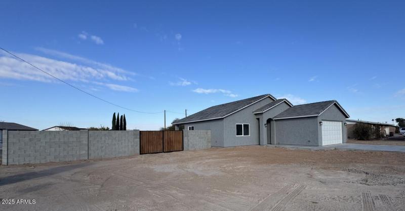 Front of home with RV gate and parking