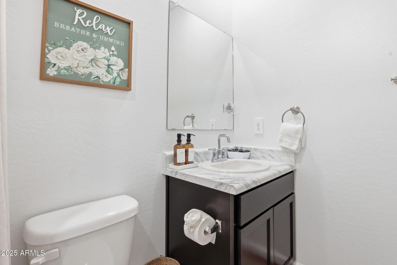 Bathroom vanity has storage under the si