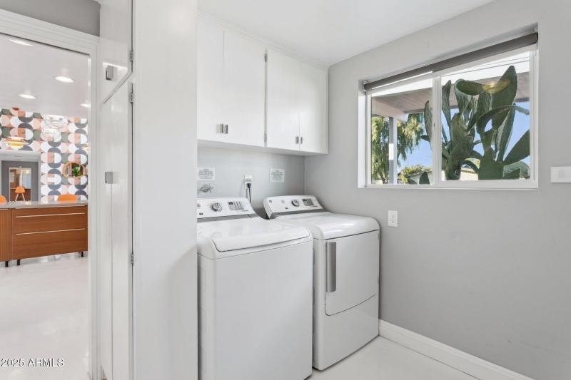 Inside laundry room with cabinetry