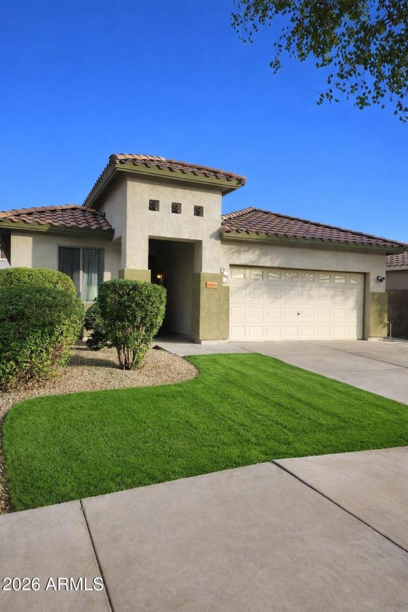 Mediterranean-style home with green lawn