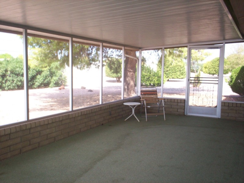 enclosed, rear patio on the west side o
