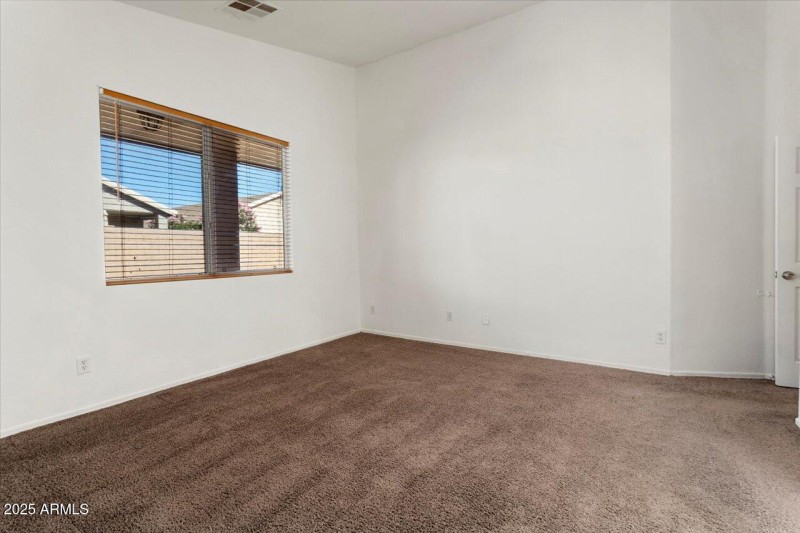 Primary Bedroom overlooks backyard
