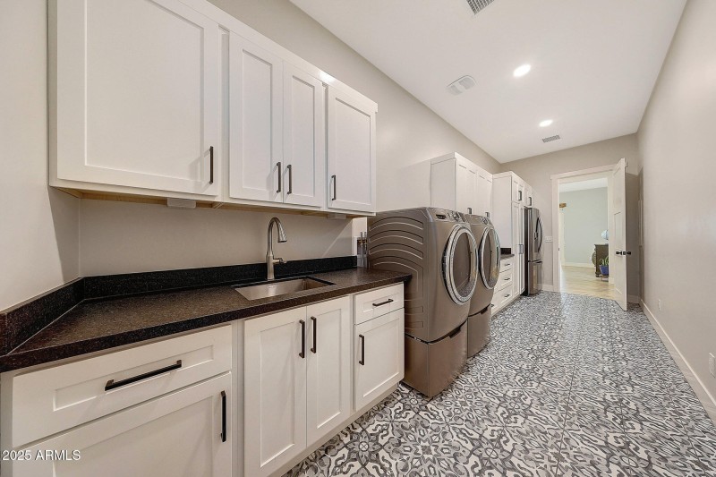 Laundry room with sink and door to outsi