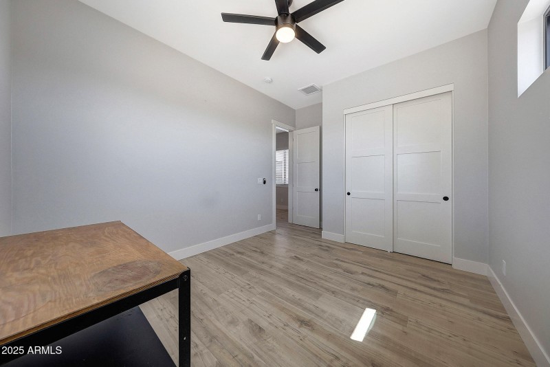 Bedroom 5 with fan and closet