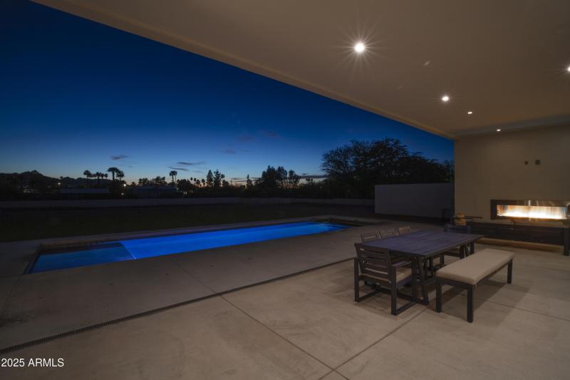 Outdoor Fireplace Overlooking Pool