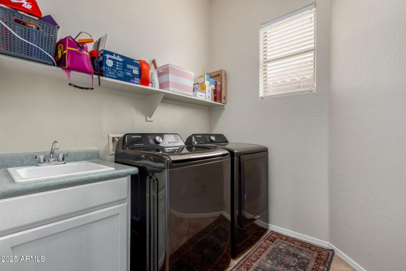Large laundry room with utility sink