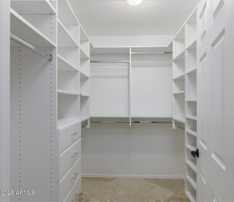 Primary bedroom walk-in closet