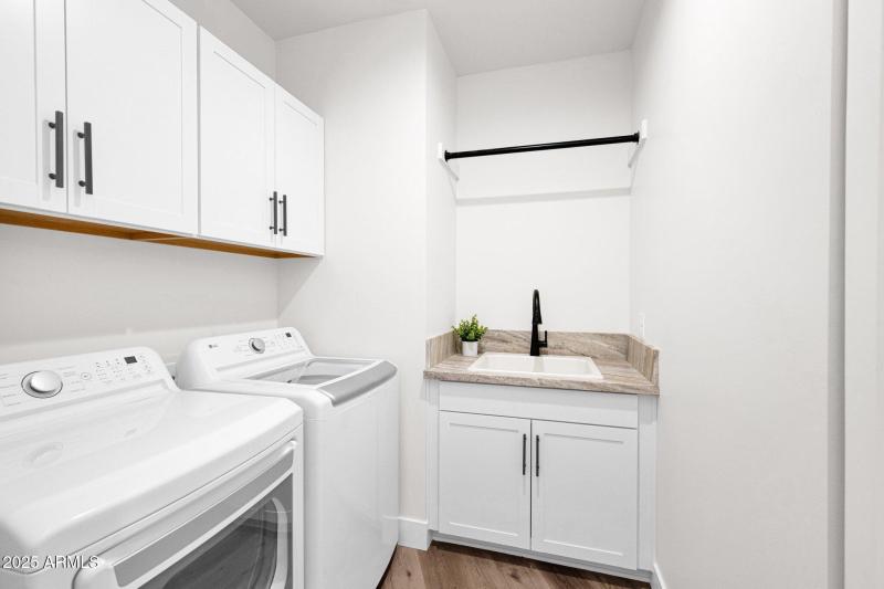 Laundry Room With Sink and Cabinetry