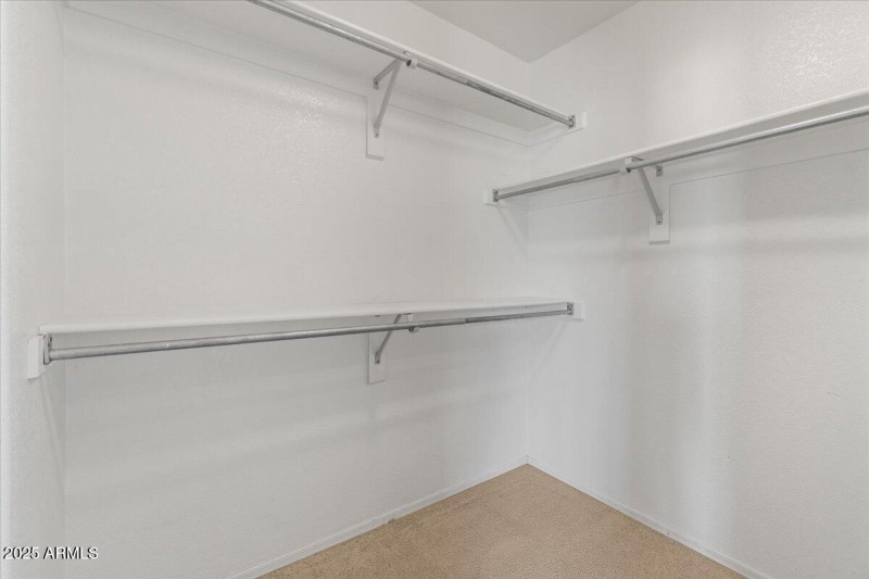 Primary bedroom walk in closet