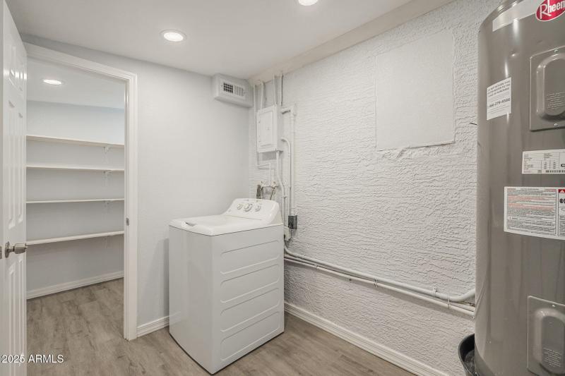 Laundry room with door leading to pantry