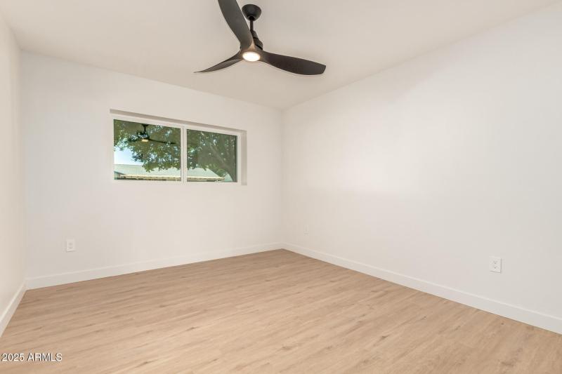 Bright Guest Room with Ceiling Fan