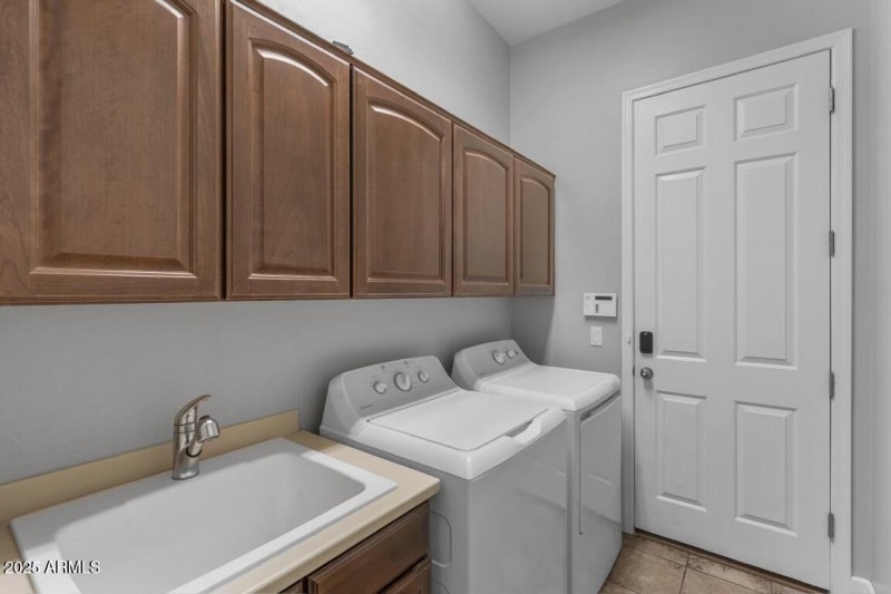 Laundry room has cabs & sink