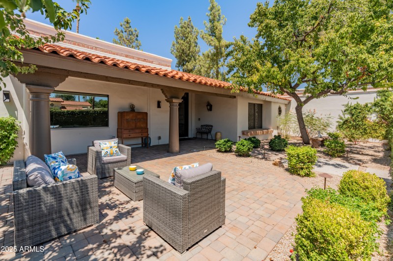 Features pavers and manicured courtyard