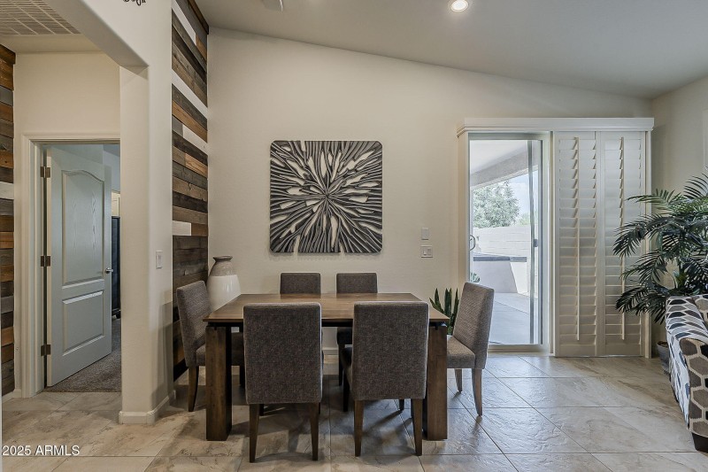 Patio door has plantation shutters.