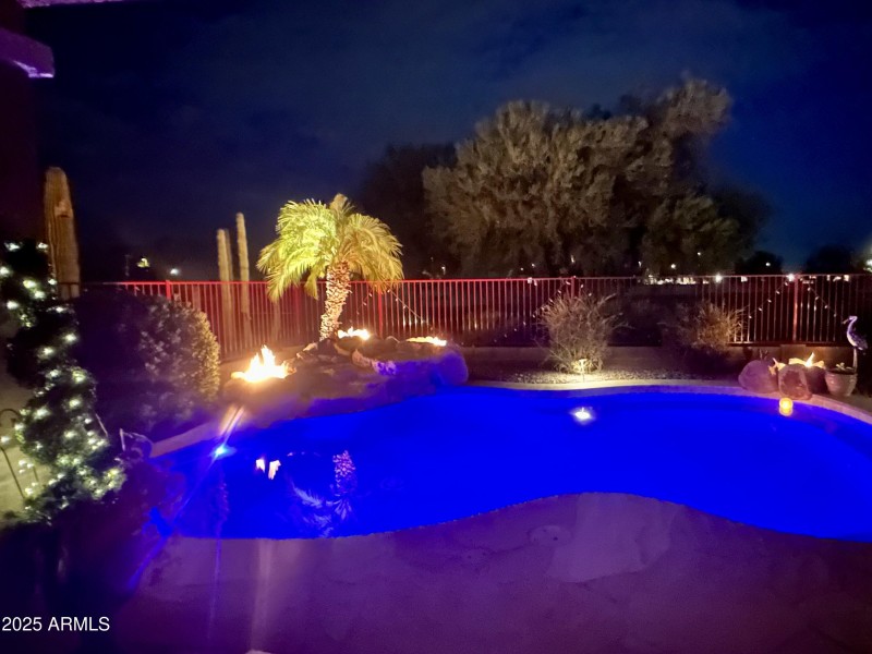 3 fire pits behind the pool waterfall