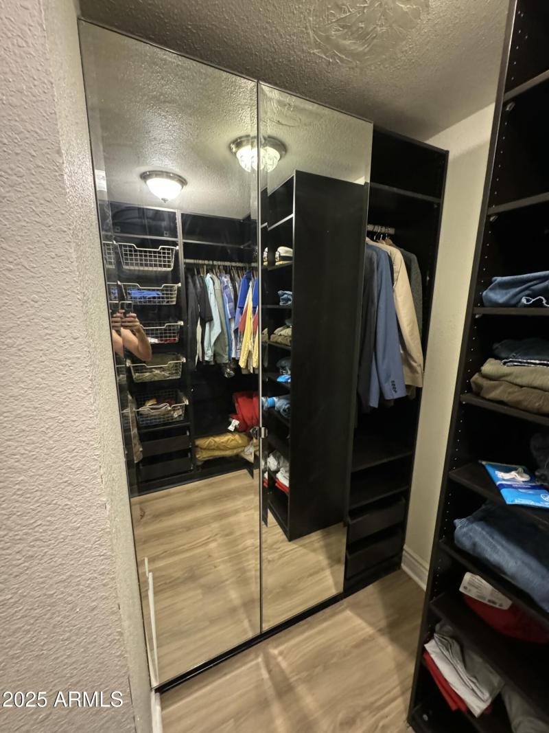 Primary walk-in closet with organizers