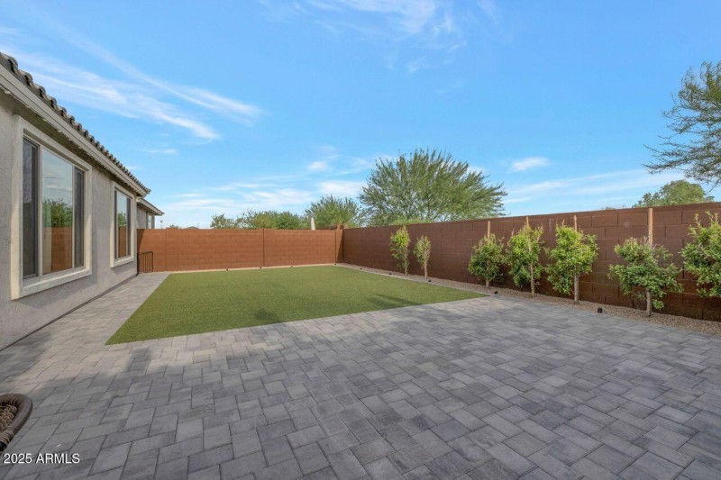 Spacious backyard with block wall