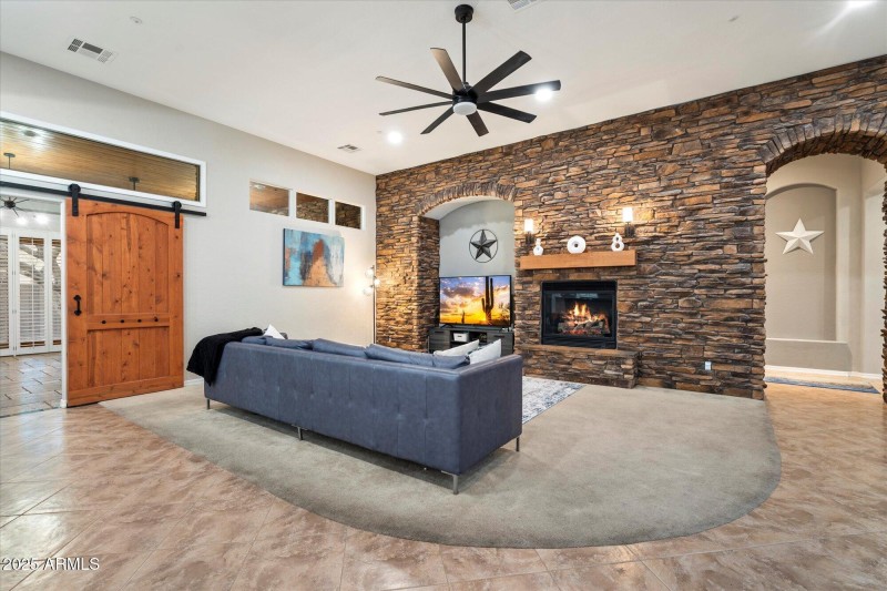 Living Room w/ Stone Accented Fireplace