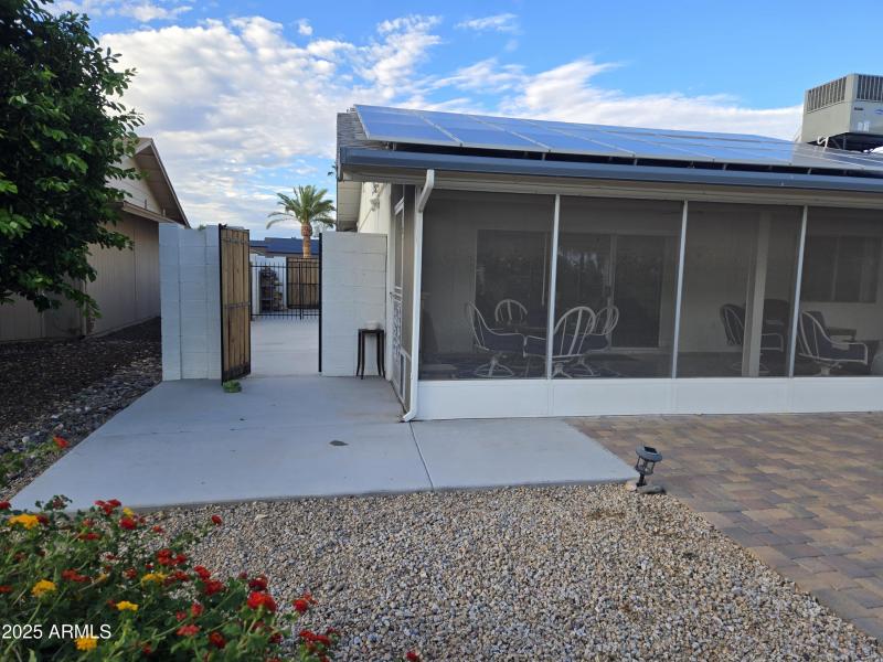 Gated storage / patio pad on west side