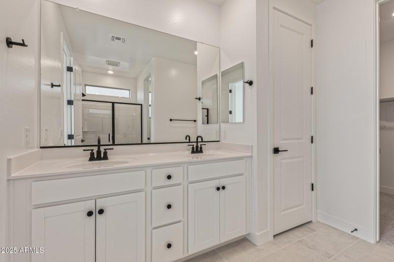 Primary Bathroom with Dual Sinks and Li