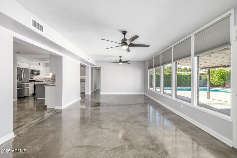 Great room with view of pool in backyard