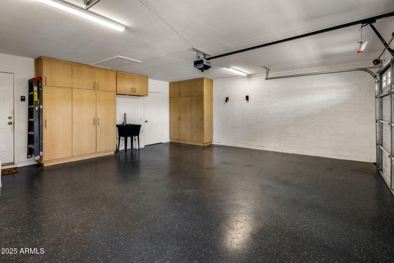 Garage with Cabinets + Storage Room