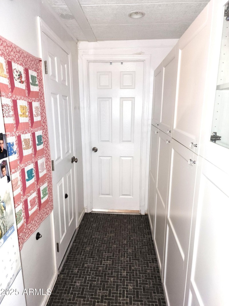 68. Door at end of kitchen hallway looki