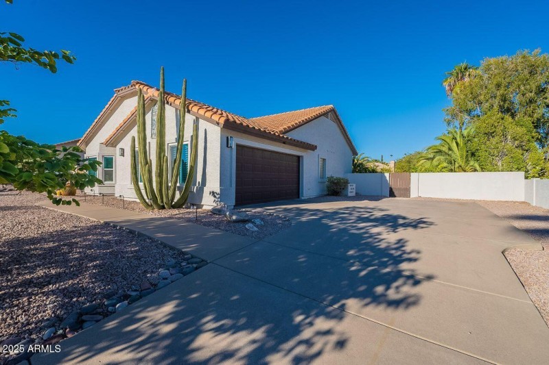 Two car garage and gate to backyard