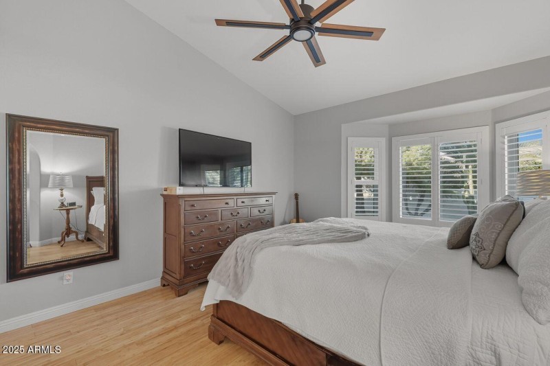 Primary bedroom overlooks backyard pool