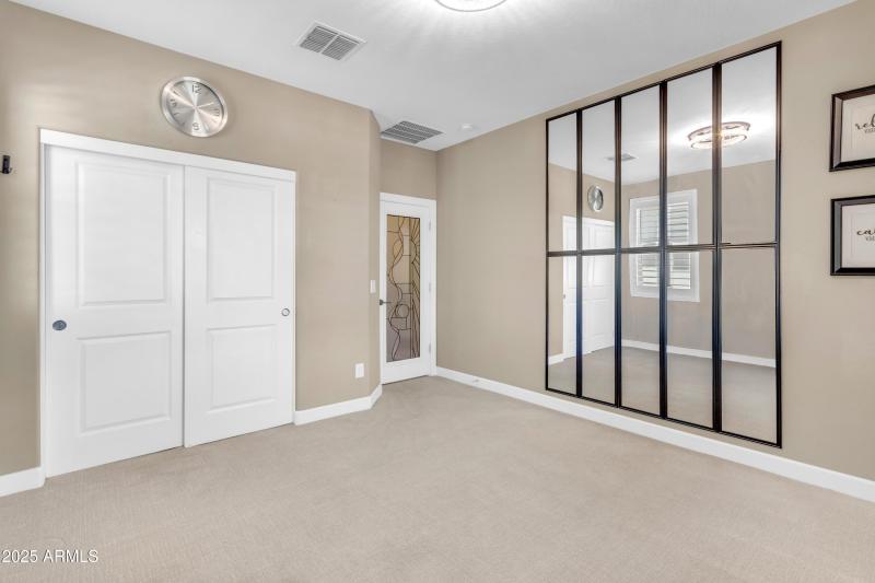 Mirrors Highlight this Secondary Bedroom