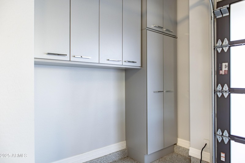 Garage cabinets with trashcan cutout