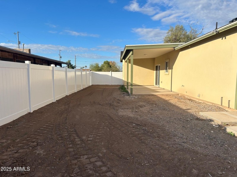 Fenced backyard with covered porch