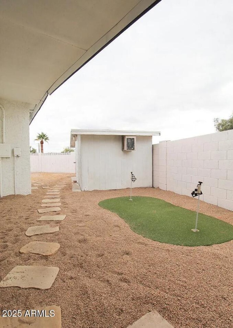 Putting green and secondary storage shed