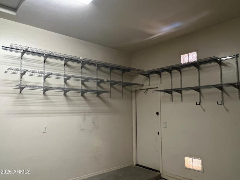 Garage with service door and shelving