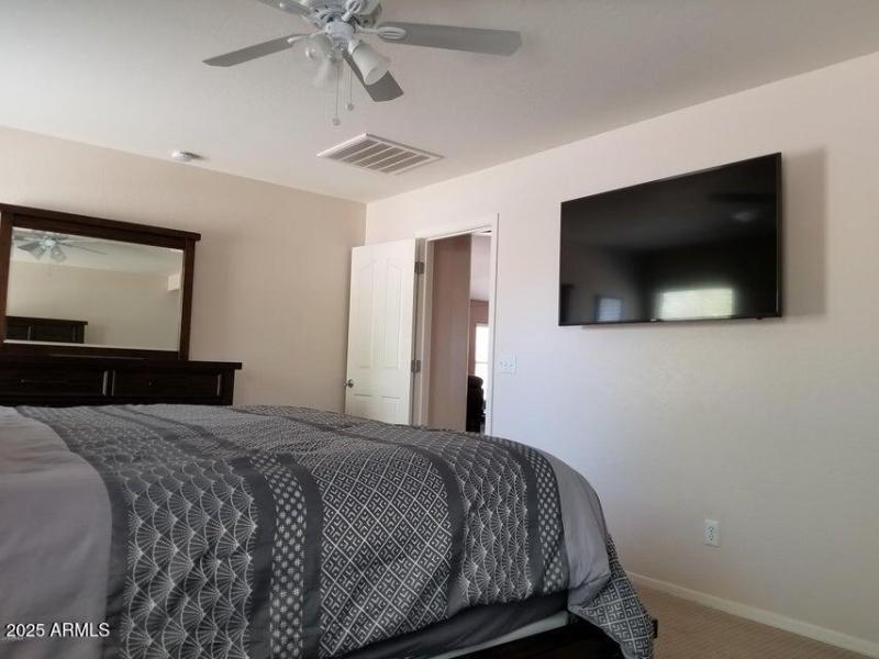 Wall mounted 55 inch TV in main bedroom