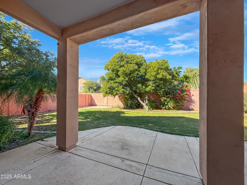 Covered Patio with Grass Backyard
