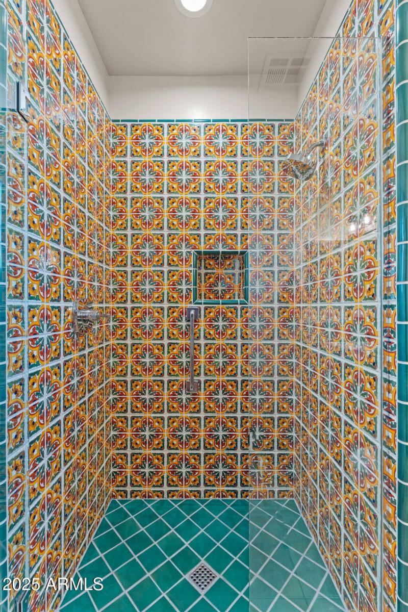 Brightly tiles walk-in guest shower