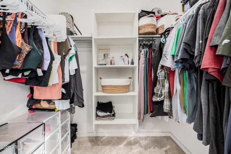 Primary bedroom walk in closet