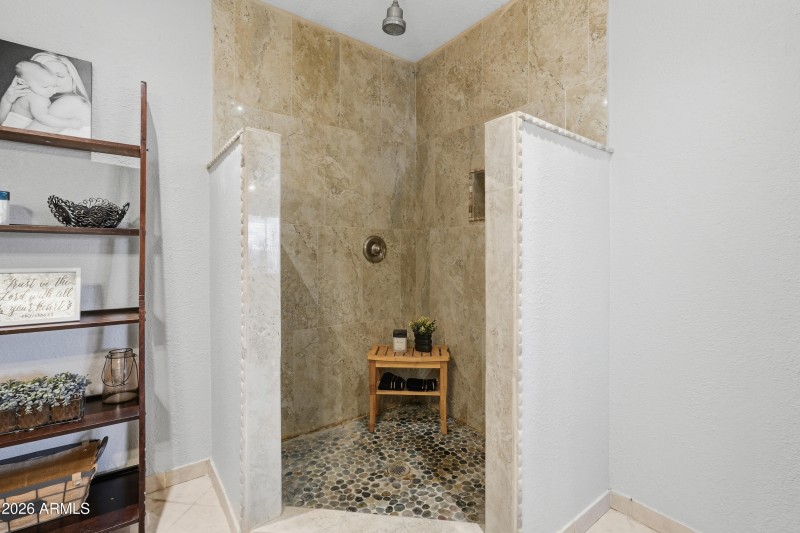 Walk-in shower tiled to the ceiling