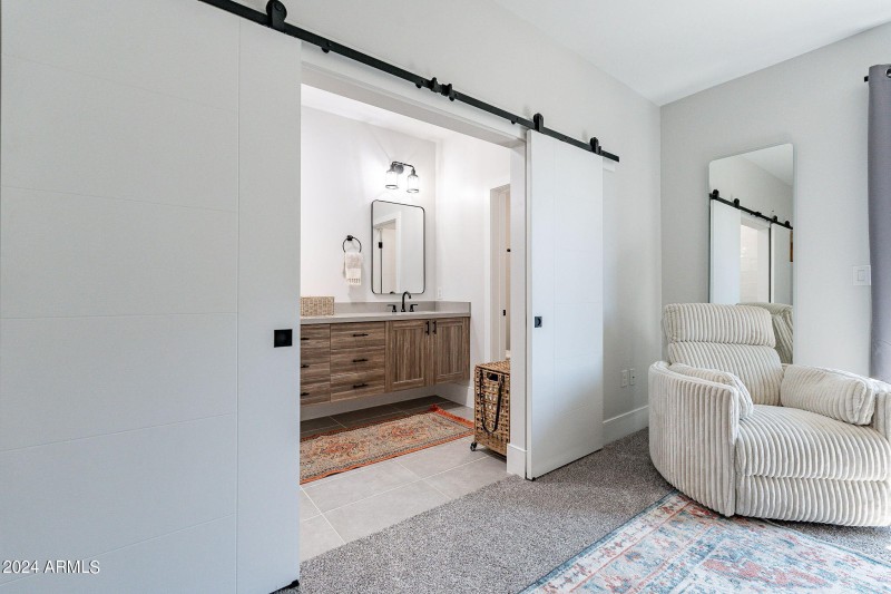 Trendy barn doors lead to the en suite