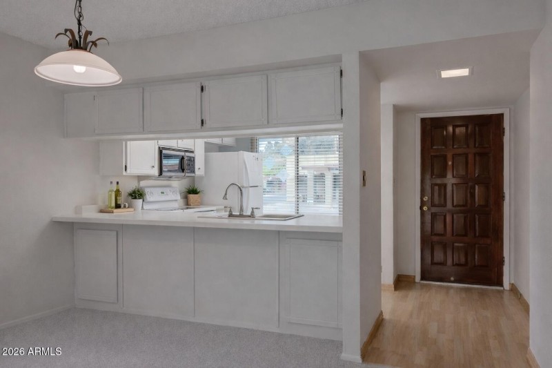 Sunny kitchen view through the entryway