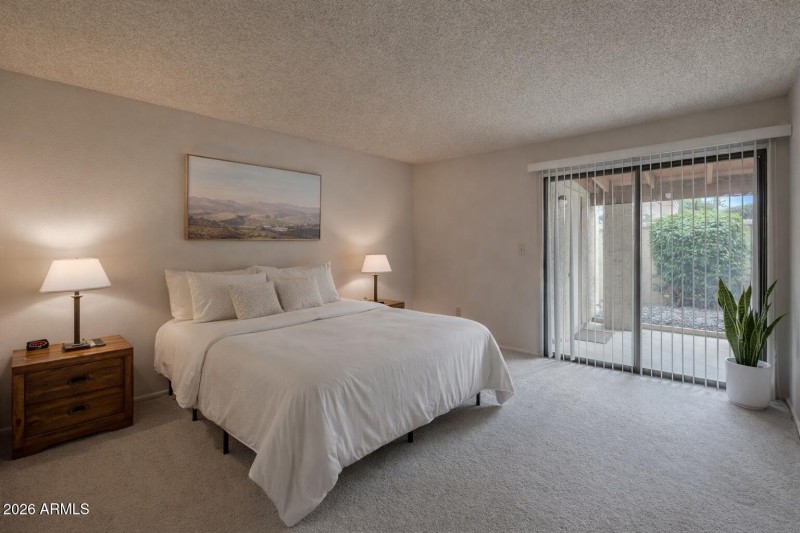 Serene bedroom with desert landscape art