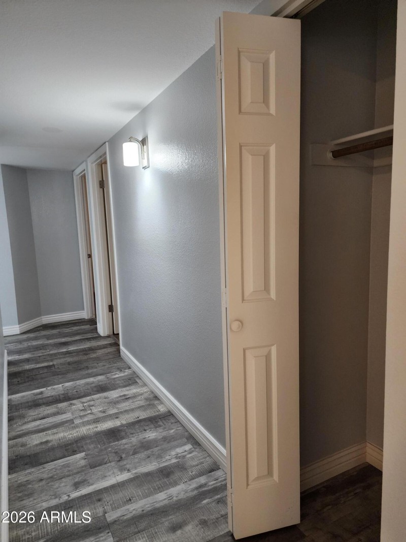 Hallway to bdrms has coat closet